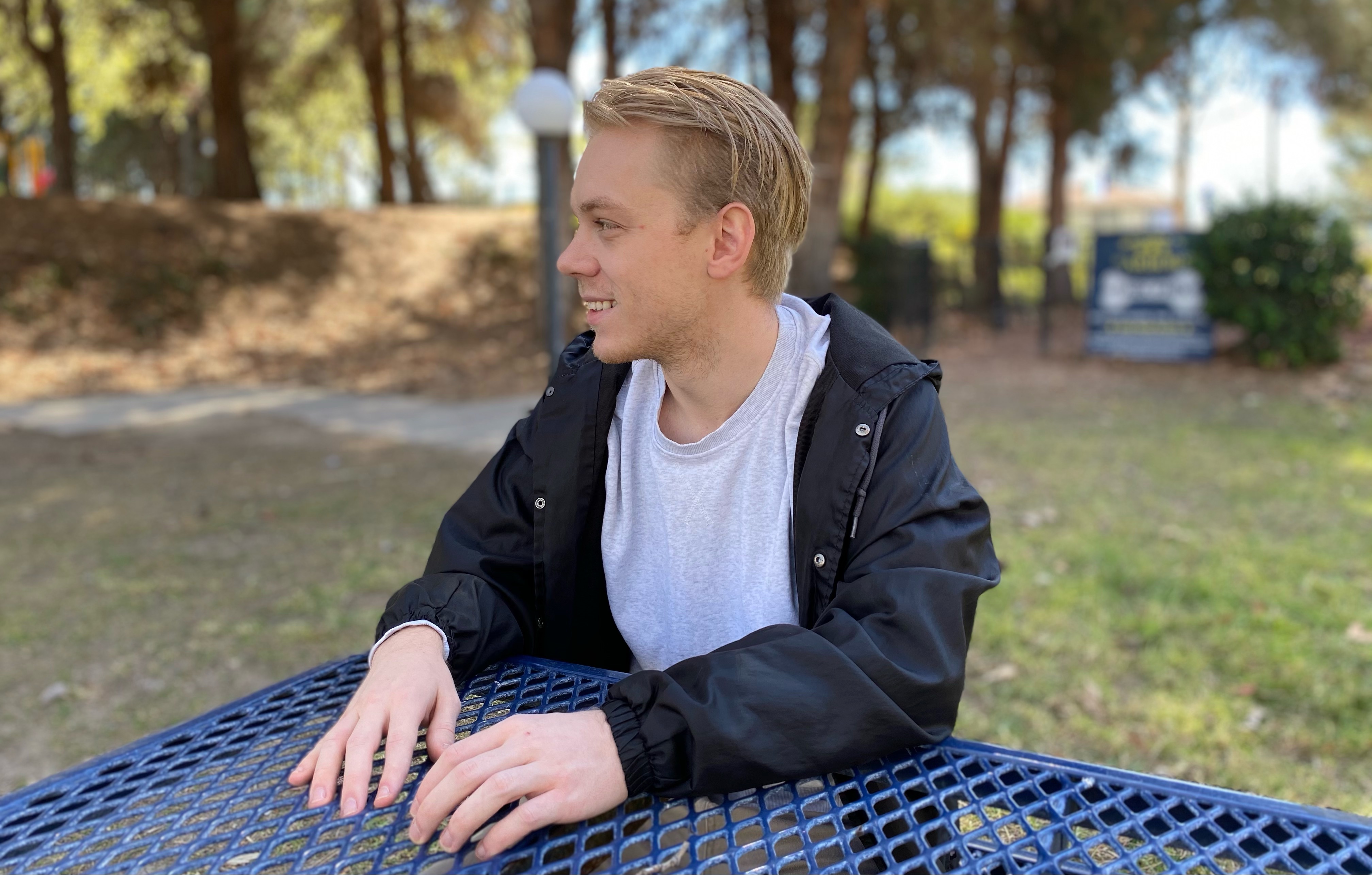 A picture of Brett Winterstrom sitting at a bench